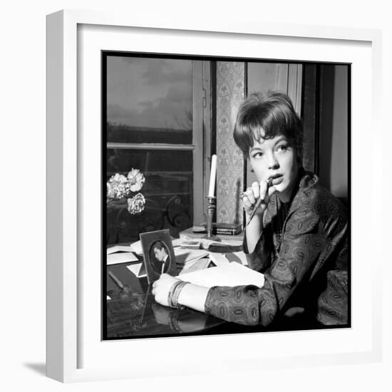 Romy Schneider, Thougthful, Trying to Write a Letter in Front of Alain Delon's Picture-Marcel Begoin-Framed Photographic Print