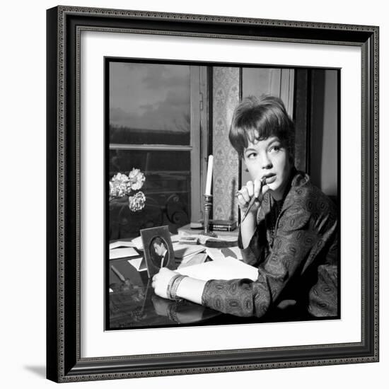 Romy Schneider, Thougthful, Trying to Write a Letter in Front of Alain Delon's Picture-Marcel Begoin-Framed Photographic Print