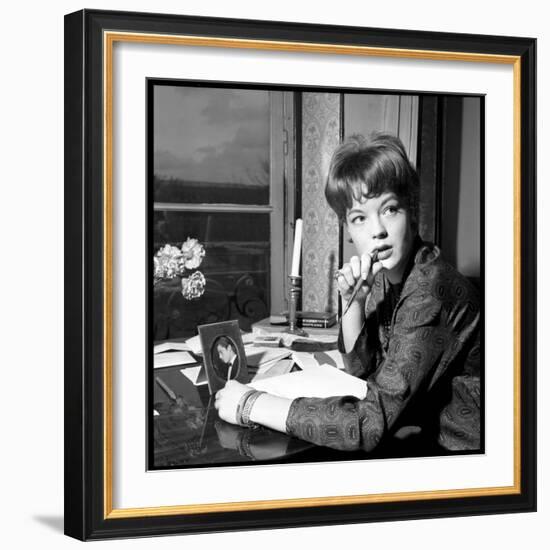 Romy Schneider, Thougthful, Trying to Write a Letter in Front of Alain Delon's Picture-Marcel Begoin-Framed Photographic Print