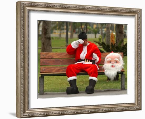 Ronald Guzman, Who Works as Santa Claus, Takes a Break in a Public Park in Lima, Peru-null-Framed Photographic Print