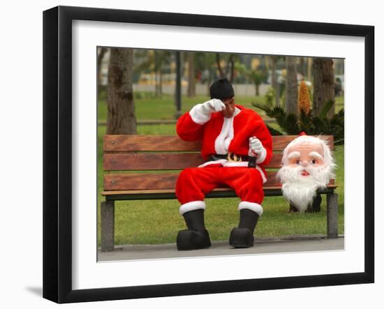 Ronald Guzman, Who Works as Santa Claus, Takes a Break in a Public Park in Lima, Peru-null-Framed Photographic Print