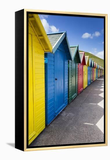 Row of Colourful Beach Huts and their Shadows with Green Hill Backdrop-Eleanor Scriven-Framed Premier Image Canvas