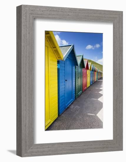 Row of Colourful Beach Huts and their Shadows with Green Hill Backdrop-Eleanor Scriven-Framed Photographic Print