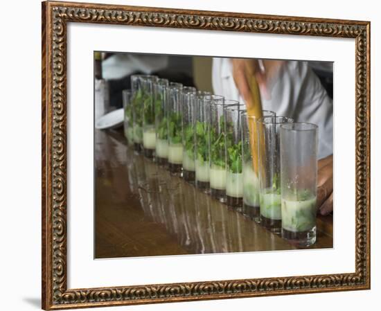 Row of Glasses on a Bar with Barman Preparing Mojito Cocktails, Habana Vieja, Havana, Cuba-Eitan Simanor-Framed Photographic Print