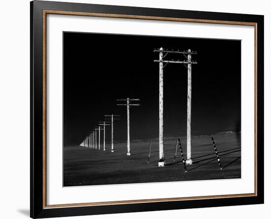 Row of Telephone Poles Along Bonneville Salt Flats-Fritz Goro-Framed Photographic Print