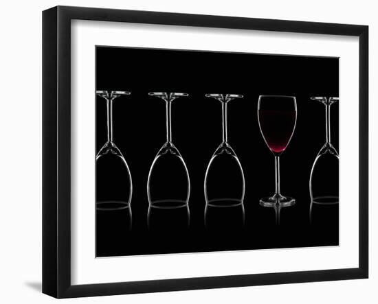 Row of Wine Glasses and a Glass of Red Wine Against a Black Background-Shawn Hempel-Framed Photographic Print