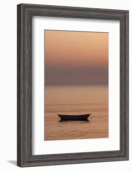 Rowboat at anchor in the water at sunset.-Tom Haseltine-Framed Photographic Print