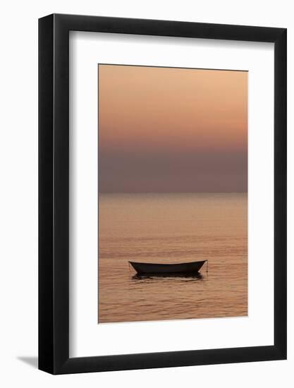 Rowboat at anchor in the water at sunset.-Tom Haseltine-Framed Photographic Print