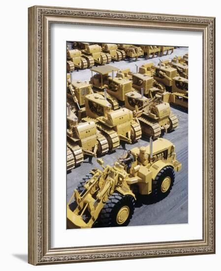 Rows of Brightly Colored Caterpillar Bulldozers Lined up at an Unidentified Factory-John Zimmerman-Framed Photographic Print