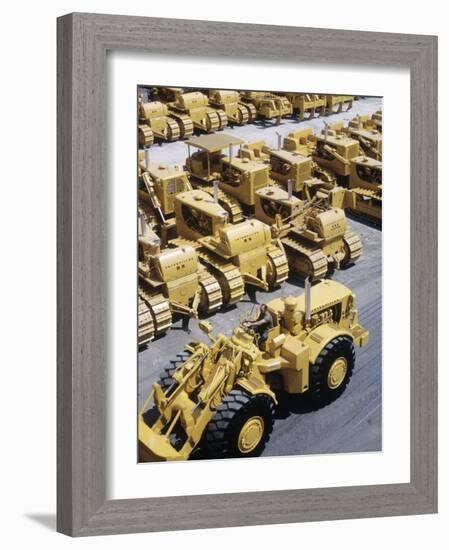 Rows of Brightly Colored Caterpillar Bulldozers Lined up at an Unidentified Factory-John Zimmerman-Framed Photographic Print