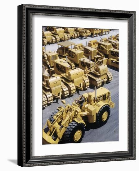 Rows of Brightly Colored Caterpillar Bulldozers Lined up at an Unidentified Factory-John Zimmerman-Framed Photographic Print