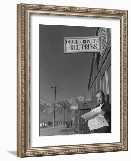 Roy Takeno, editor of Manzanar Free Press, reading the paper at the Manzanar War Relocation Center-Ansel Adams-Framed Photographic Print