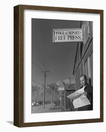 Roy Takeno, editor of Manzanar Free Press, reading the paper at the Manzanar War Relocation Center-Ansel Adams-Framed Photographic Print
