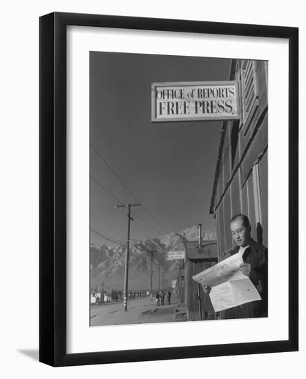 Roy Takeno, editor of Manzanar Free Press, reading the paper at the Manzanar War Relocation Center-Ansel Adams-Framed Photographic Print