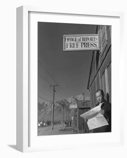 Roy Takeno, editor of Manzanar Free Press, reading the paper at the Manzanar War Relocation Center-Ansel Adams-Framed Photographic Print