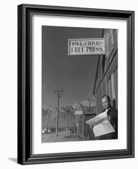 Roy Takeno, editor of Manzanar Free Press, reading the paper at the Manzanar War Relocation Center-Ansel Adams-Framed Photographic Print