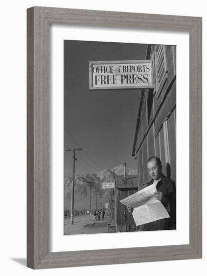 Roy Takeno Reading Paper in Front of Office-Ansel Adams-Framed Art Print