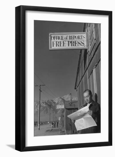 Roy Takeno Reading Paper in Front of Office-Ansel Adams-Framed Art Print