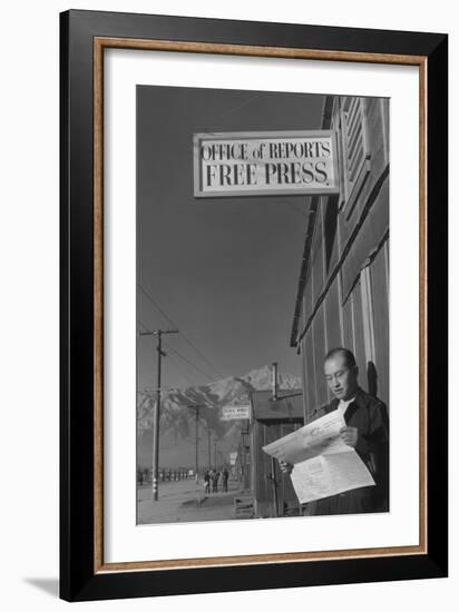 Roy Takeno Reading Paper in Front of Office-Ansel Adams-Framed Art Print