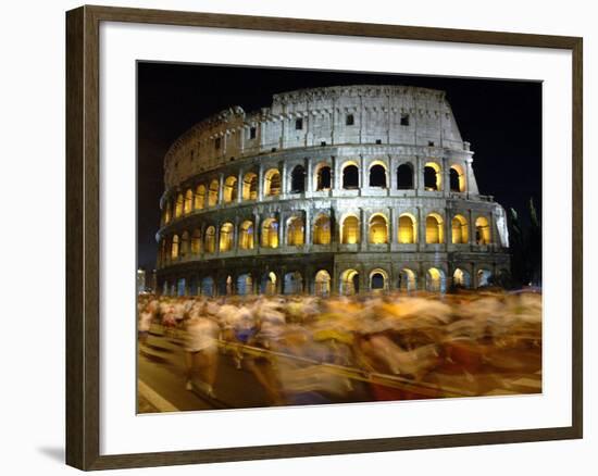 Runners Make Their Way Past the Colosseum in Rome--Framed Photographic Print