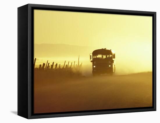 Rural School Bus Driving Along Dusty Country Road, Oregon, USA-William Sutton-Framed Premier Image Canvas