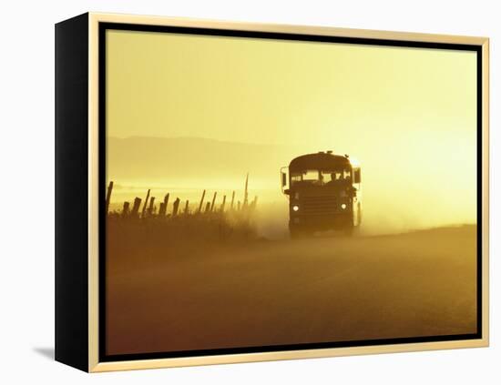 Rural School Bus Driving Along Dusty Country Road, Oregon, USA-William Sutton-Framed Premier Image Canvas