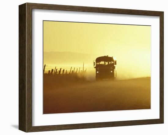 Rural School Bus Driving Along Dusty Country Road, Oregon, USA-William Sutton-Framed Photographic Print