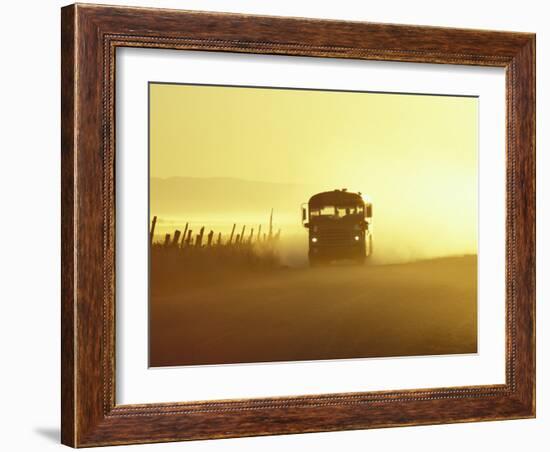 Rural School Bus Driving Along Dusty Country Road, Oregon, USA-William Sutton-Framed Photographic Print