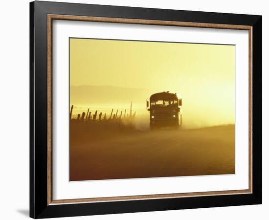 Rural School Bus Driving Along Dusty Country Road, Oregon, USA-William Sutton-Framed Photographic Print