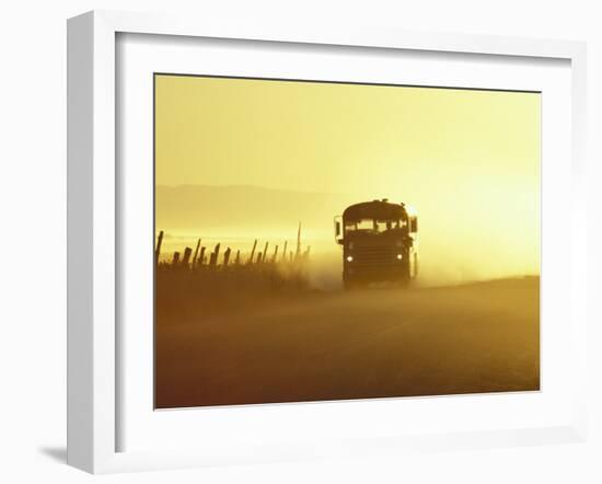 Rural School Bus Driving Along Dusty Country Road, Oregon, USA-William Sutton-Framed Photographic Print