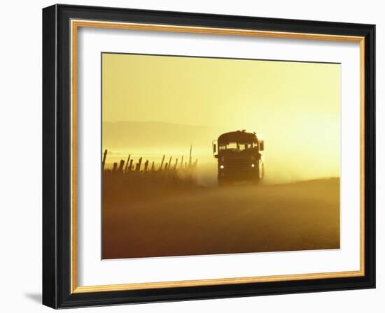 Rural School Bus Driving Along Dusty Country Road, Oregon, USA-William Sutton-Framed Photographic Print