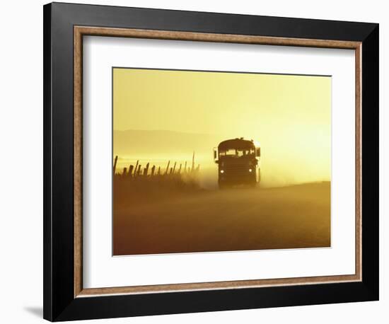Rural School Bus Driving Along Dusty Country Road, Oregon, USA-William Sutton-Framed Photographic Print