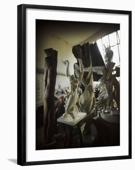 Russian Sculptor Ossip Zadkine Sitting in His Paris Studio Among Towering Sculptures-Gjon Mili-Framed Premium Photographic Print