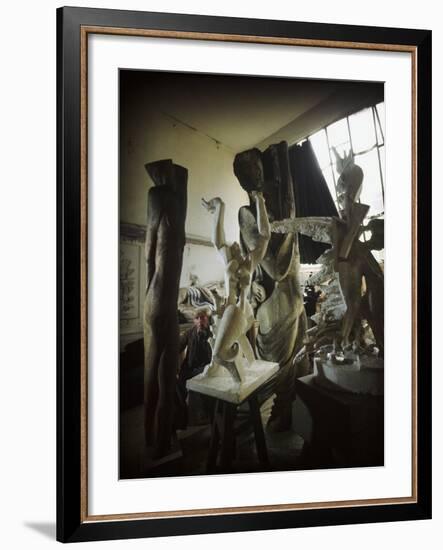 Russian Sculptor Ossip Zadkine Sitting in His Paris Studio Among Towering Sculptures-Gjon Mili-Framed Premium Photographic Print