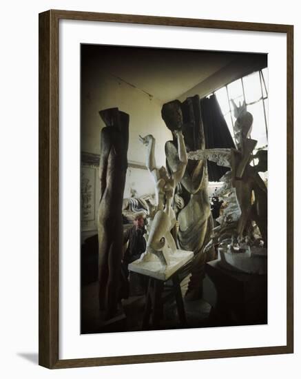 Russian Sculptor Ossip Zadkine Sitting in His Paris Studio Among Towering Sculptures-Gjon Mili-Framed Premium Photographic Print