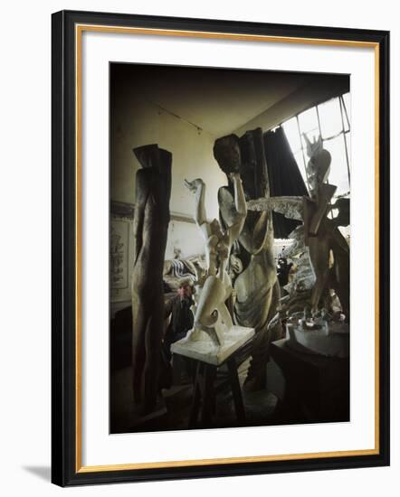 Russian Sculptor Ossip Zadkine Sitting in His Paris Studio Among Towering Sculptures-Gjon Mili-Framed Premium Photographic Print