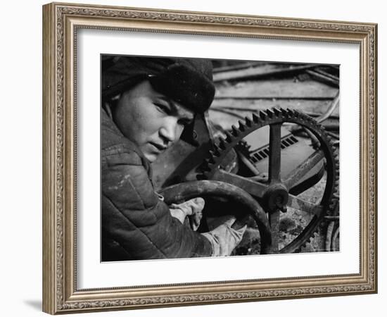 Russian Steel Worker Turning Gear Wheel in a Steel Mill-Margaret Bourke-White-Framed Photographic Print