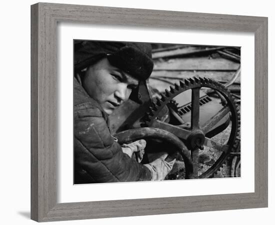 Russian Steel Worker Turning Gear Wheel in a Steel Mill-Margaret Bourke-White-Framed Photographic Print