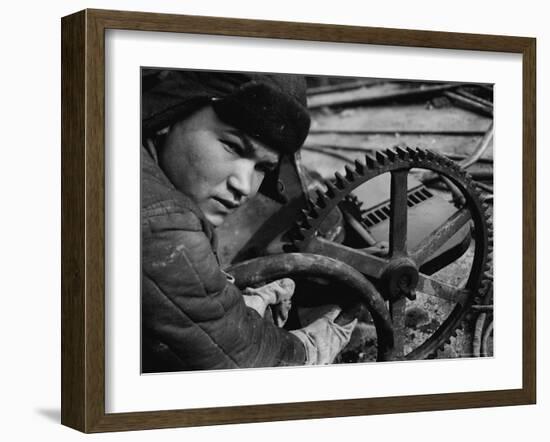 Russian Steel Worker Turning Gear Wheel in a Steel Mill-Margaret Bourke-White-Framed Photographic Print