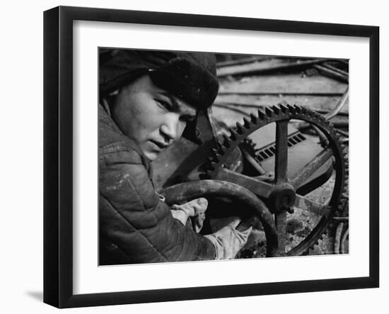 Russian Steel Worker Turning Gear Wheel in a Steel Mill-Margaret Bourke-White-Framed Photographic Print