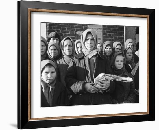 Russian Woman Grimly Holding a Slab of Meat as Other Peasant Women Staunchly Stand by in Siberia-Margaret Bourke-White-Framed Photographic Print