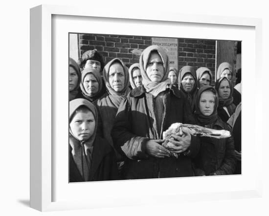 Russian Woman Grimly Holding a Slab of Meat as Other Peasant Women Staunchly Stand by in Siberia-Margaret Bourke-White-Framed Photographic Print