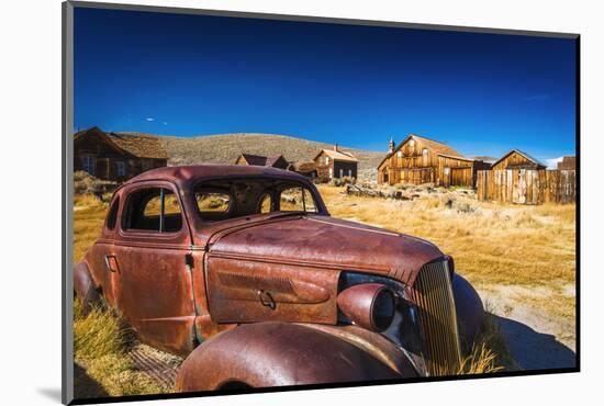 Rusted car and buildings, Bodie State Historic Park, California, USA-Russ Bishop-Mounted Photographic Print