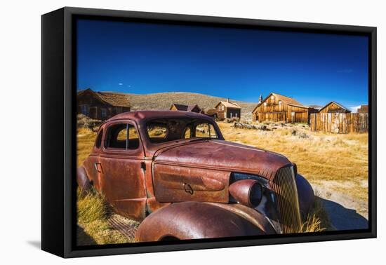 Rusted car and buildings, Bodie State Historic Park, California, USA-Russ Bishop-Framed Premier Image Canvas