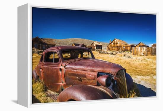 Rusted car and buildings, Bodie State Historic Park, California, USA-Russ Bishop-Framed Premier Image Canvas