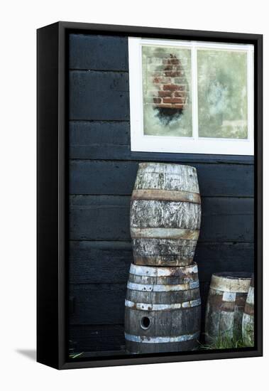 Rustic Barrels Lined Up Along an Old House Below a Window-Sheila Haddad-Framed Premier Image Canvas