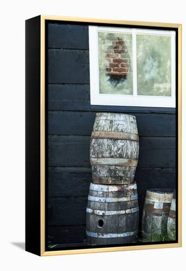 Rustic Barrels Lined Up Along an Old House Below a Window-Sheila Haddad-Framed Premier Image Canvas