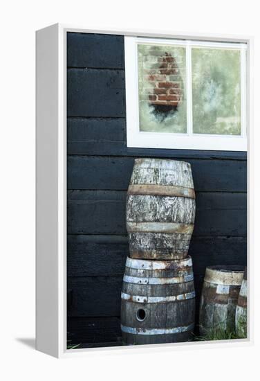 Rustic Barrels Lined Up Along an Old House Below a Window-Sheila Haddad-Framed Premier Image Canvas