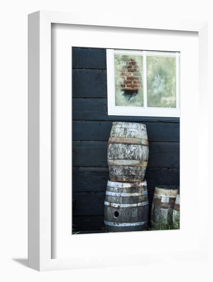 Rustic Barrels Lined Up Along an Old House Below a Window-Sheila Haddad-Framed Photographic Print