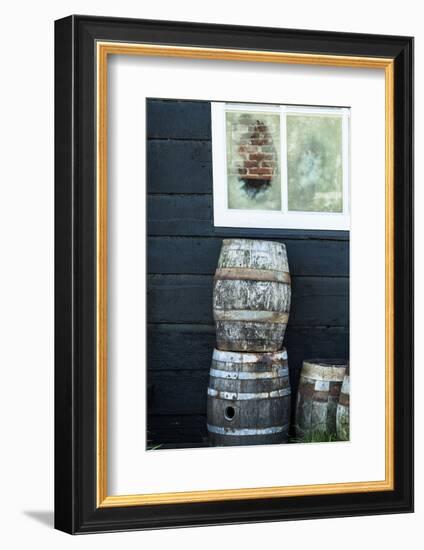 Rustic Barrels Lined Up Along an Old House Below a Window-Sheila Haddad-Framed Photographic Print